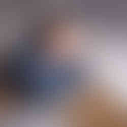 Des Moines, Iowa Newborn Photography - newborn baby boy with dark hair in a bucket with blue fur and jut rope , asleep by facing forward