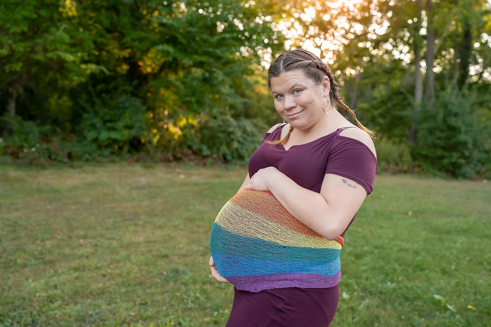 Des Moines and Ames, Iowa maternity photographer - pregnant woman has a rainbow colored wrap around her belly