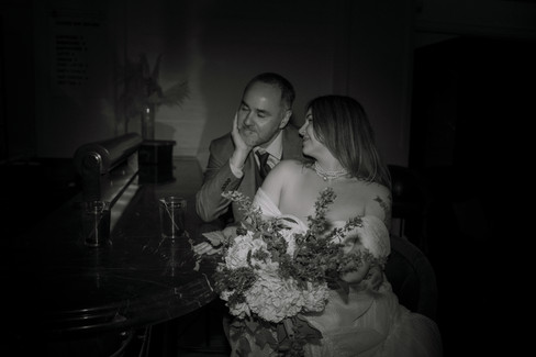 Norwalk and Des Moines, Iowa couples photographer - black and white image of a couple in formal wear sitting at a bar.