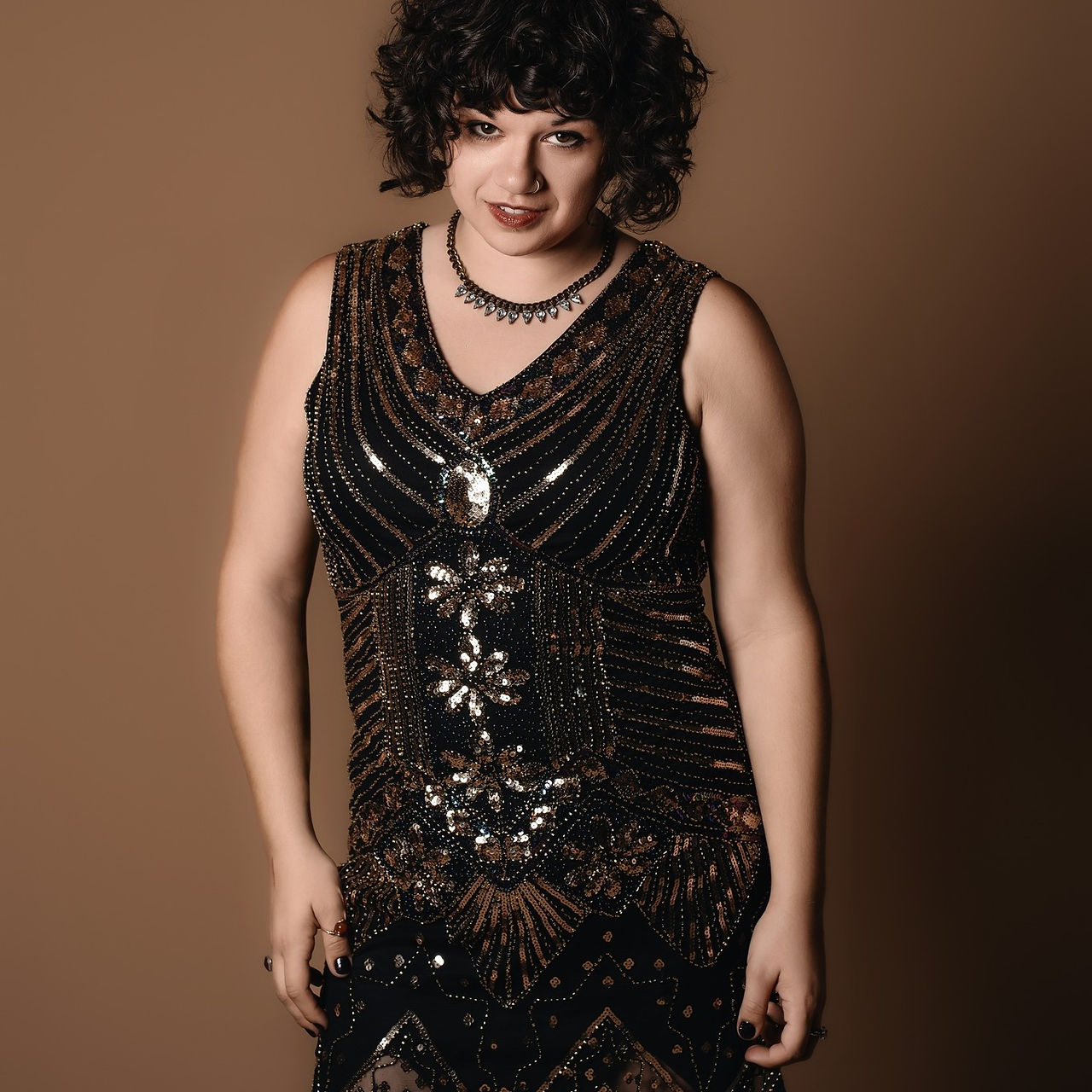 Des Moines and Norwalk, Iowa photography - woman in black flapper style dress smiles seductively
