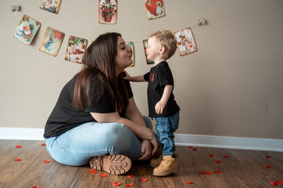 Des Moines, Iowa children and family photography - siblings (teen girl and toddler boy) looking at each other and making kissy faces.