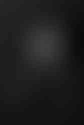 Des Moines, Iowa Newborn Photographer - black and white image of newborn baby on his back looking to the side.