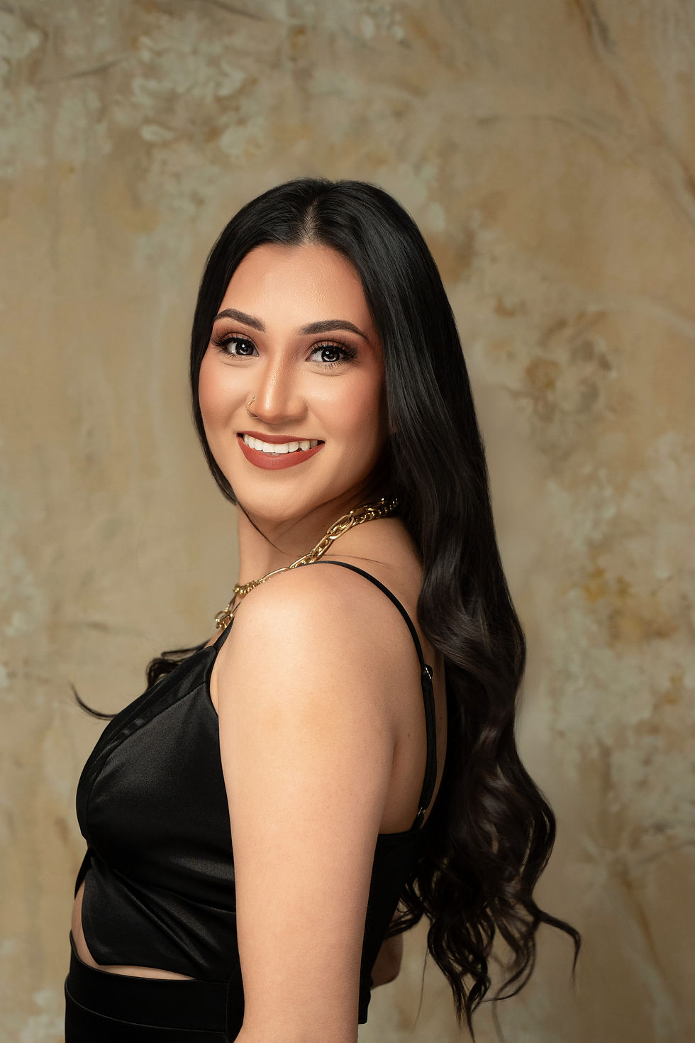 Des Moines, Iowa headshot photography - adult woman with long black hair and a black dress is posed smiling