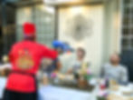 Hibachi chef shooting sake with a water gun into guests mouth