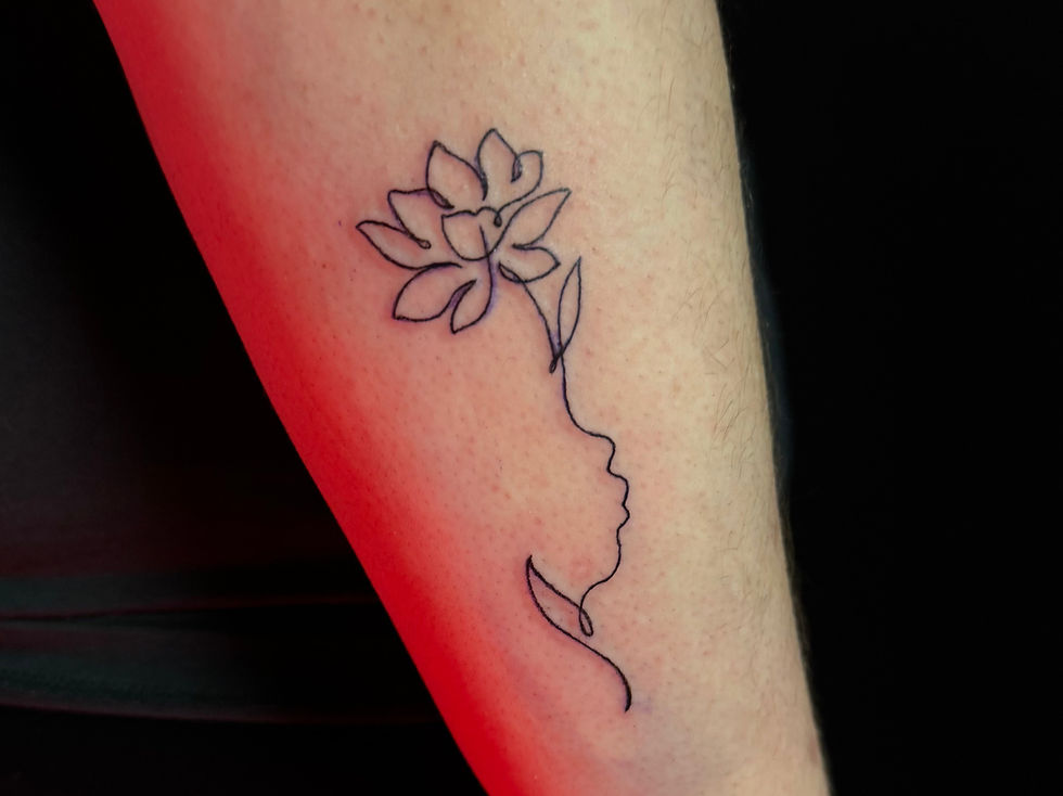 Close-up view of a small, simple tattoo on a wrist