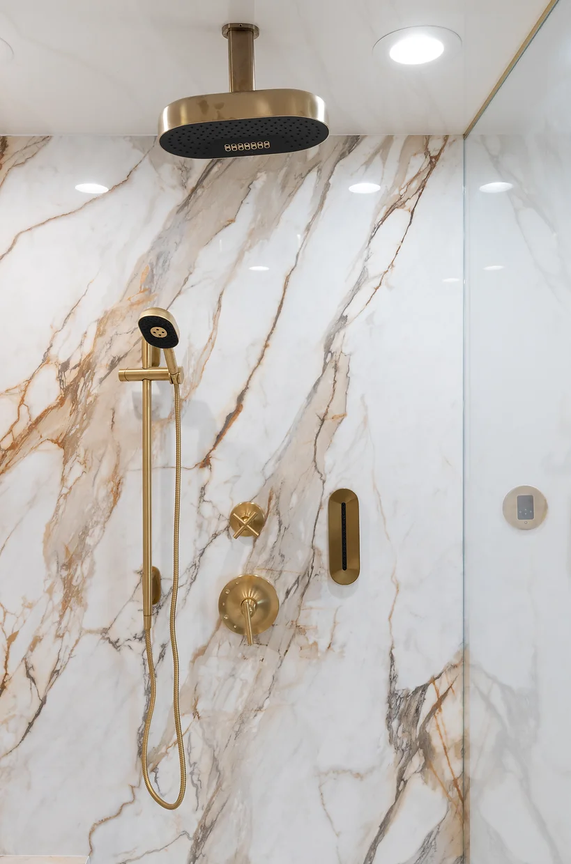 Gold shower head in Newport Beach Harbor master bathroom