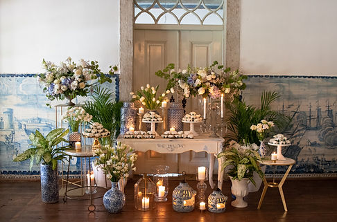 Beatiful desination wedding dessert table decorate within the blue theme and portuguese tiles. Flowers for the decorations.