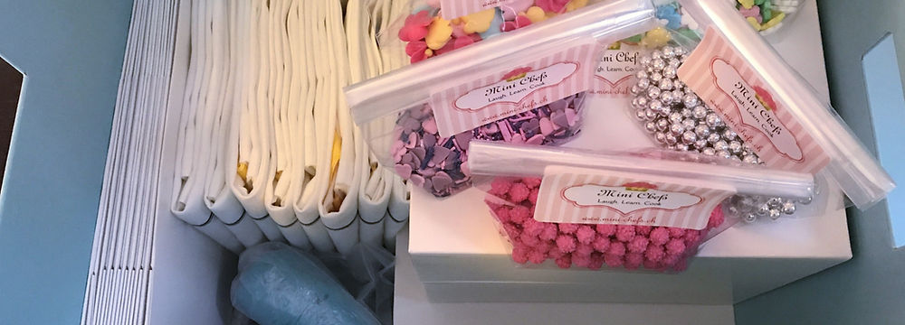 A DYI baking box with sprinkles, piping bags with different icings