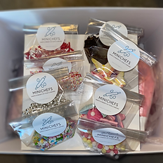 A DYI baking box with sprinkles, piping bags with different icings