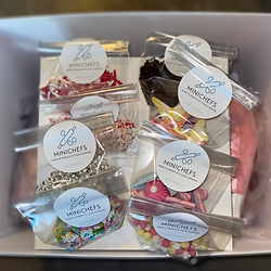 A DYI baking box with sprinkles, piping bags with different icings