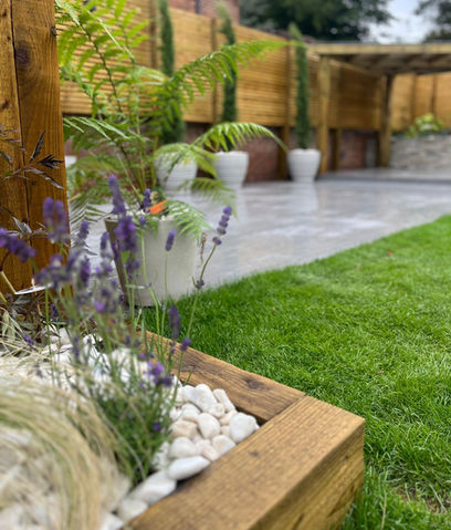 Raised beds - decorative pebble - stadium turf - porcelain patio