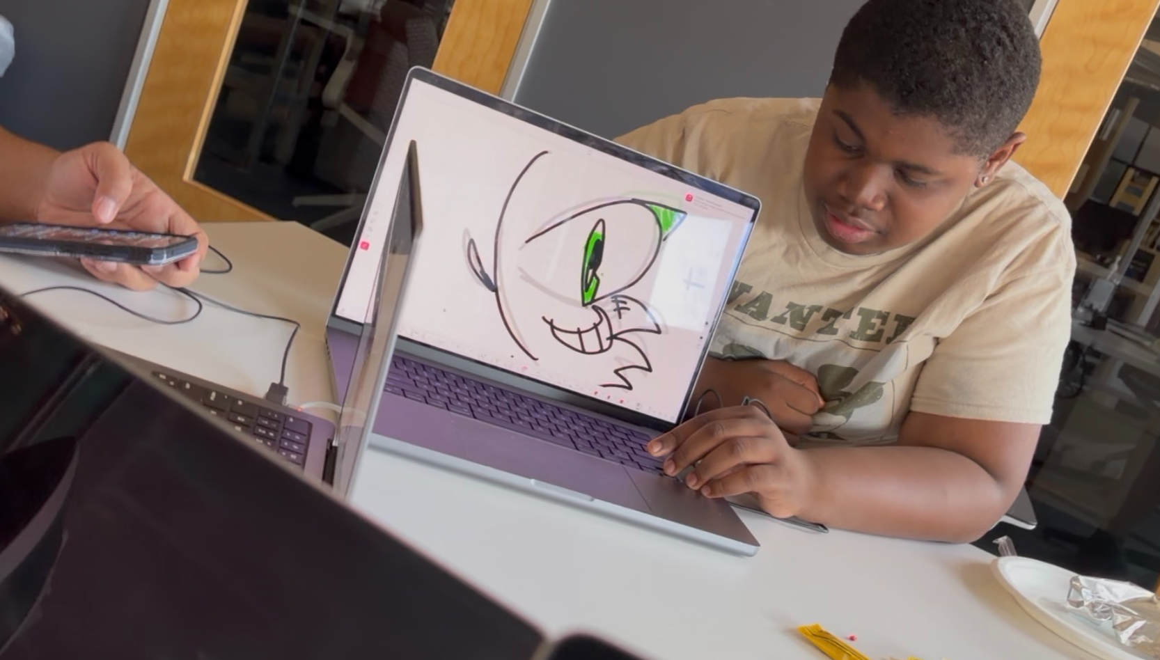 Students collaborating on creative animation and digital art projects.