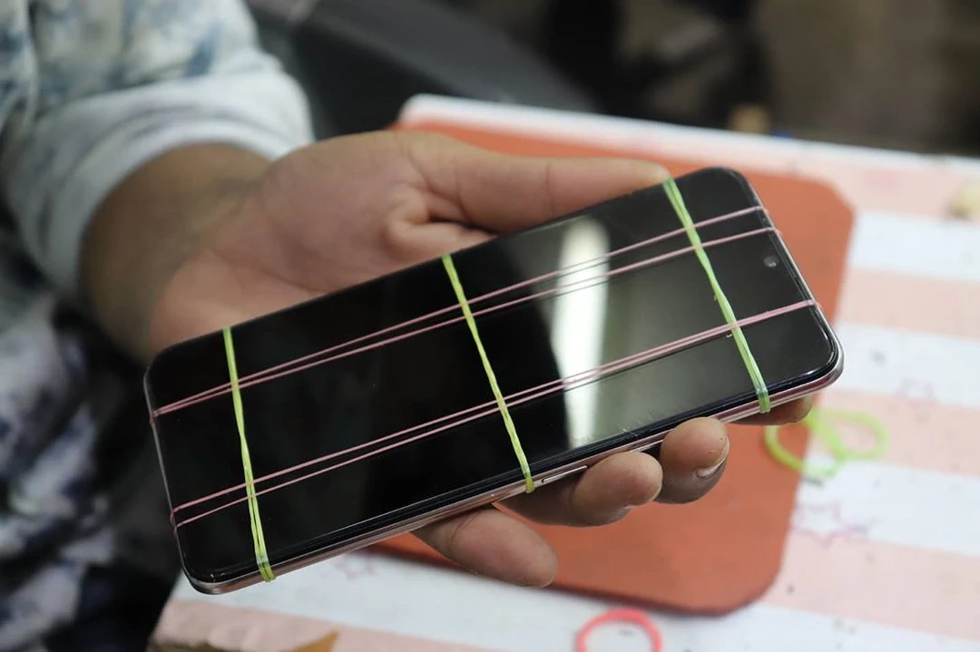 Smartphone Display Combo Replacement Original secured by bands.