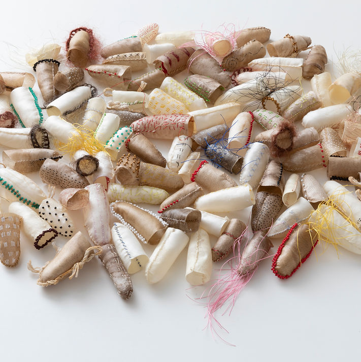 Reindeer and sheep rawhide, glass bead, human hair, acrylic paint, steel pins, nylon thread, dimensions variable. Collection of the Anchorage Museum. Photographs by Chris Arend.