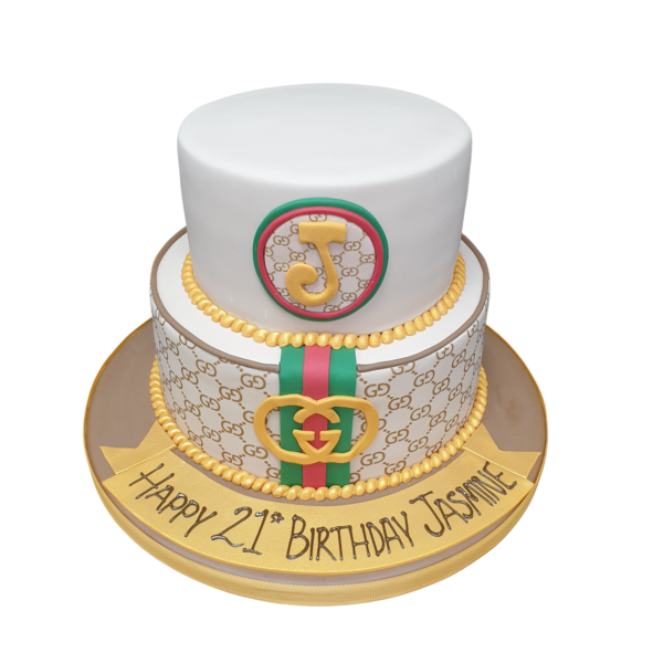 Luxurious Gucci-themed fondant cake featuring iconic double G logo, green and red stripes, and intricate detailing, perfect for fashion-forward celebrations.
