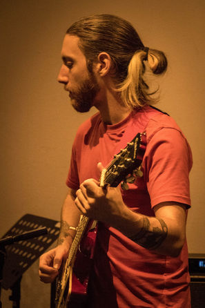 Kris plays guitar