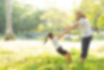 Two people playing in the yard