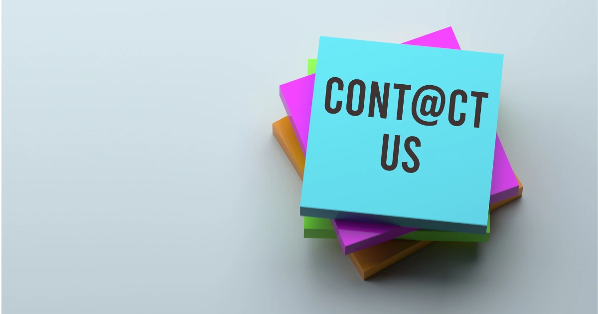 Colorful sheets of paper with Contact Us written on the topmost paper