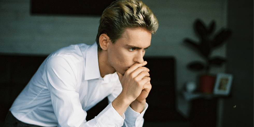 nervous young man sitting alone and thinking