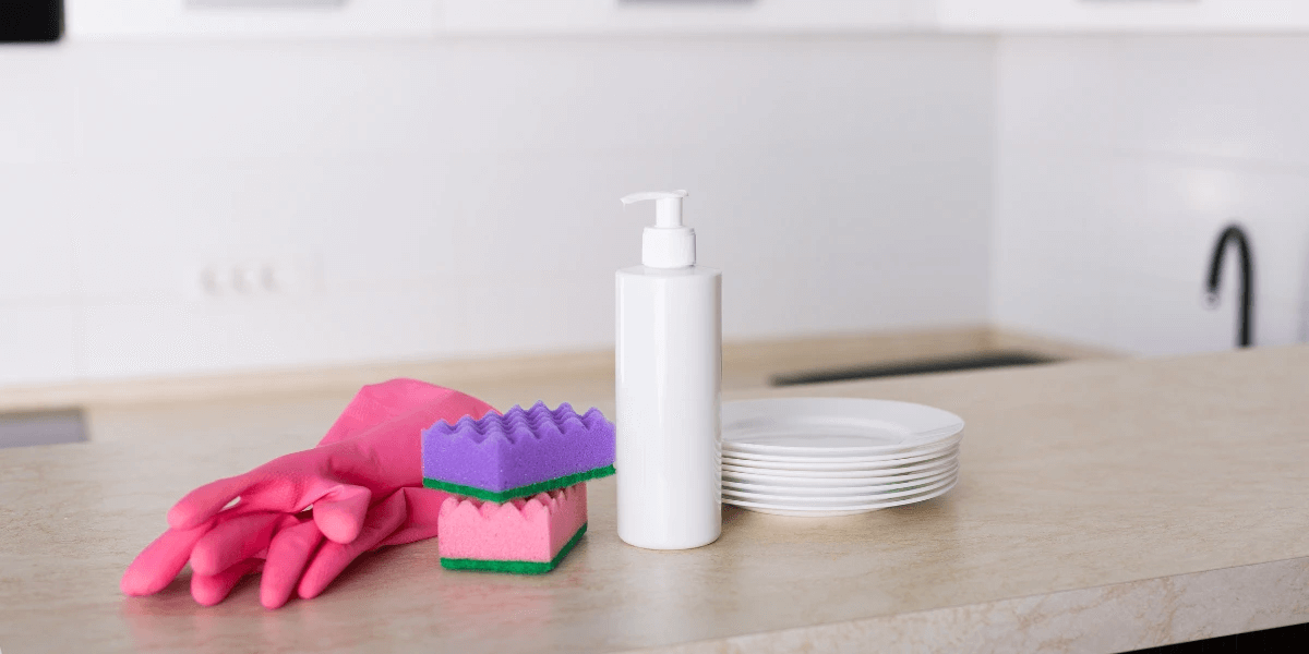 Clean kitchen counter with clean dishes and cleaning tools