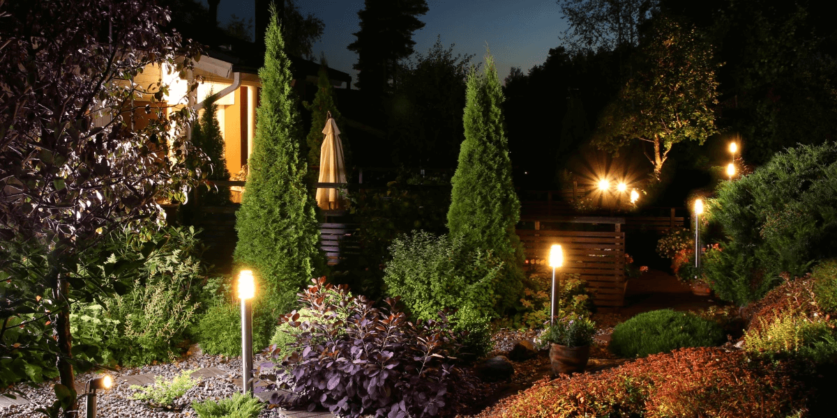 A pretty home garden illuminated by outdoorlighting