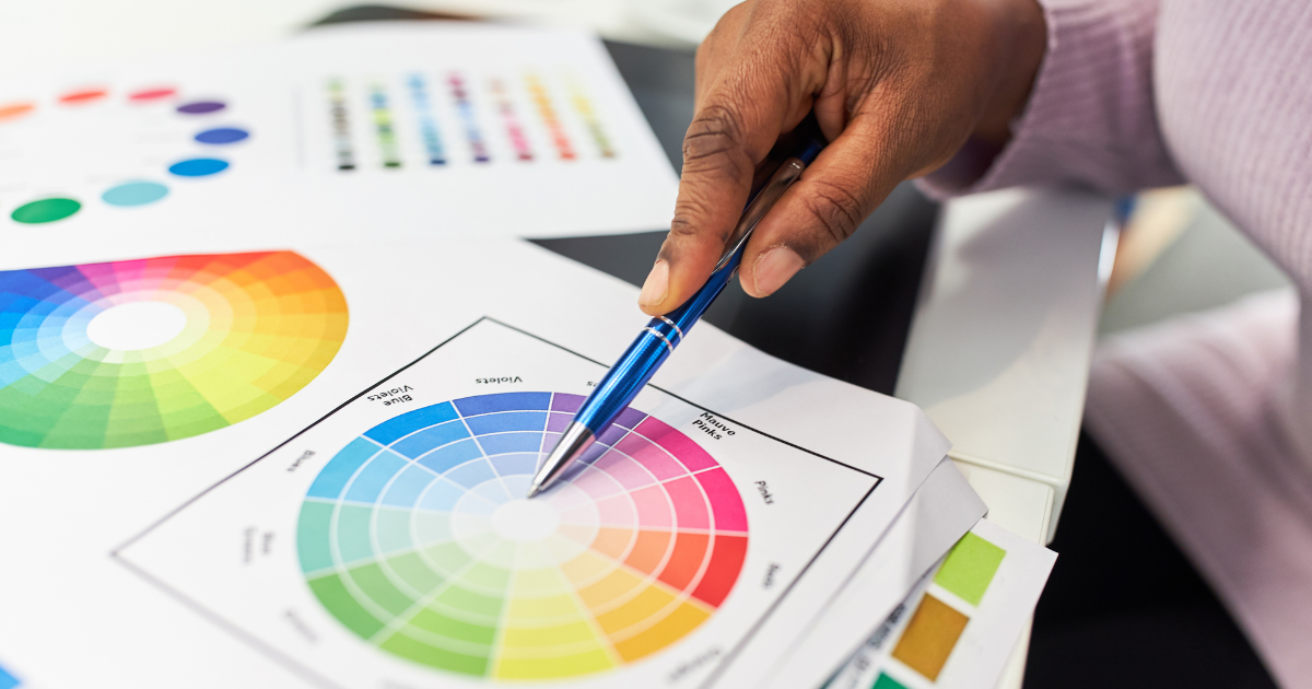 Designer hand on a color wheel