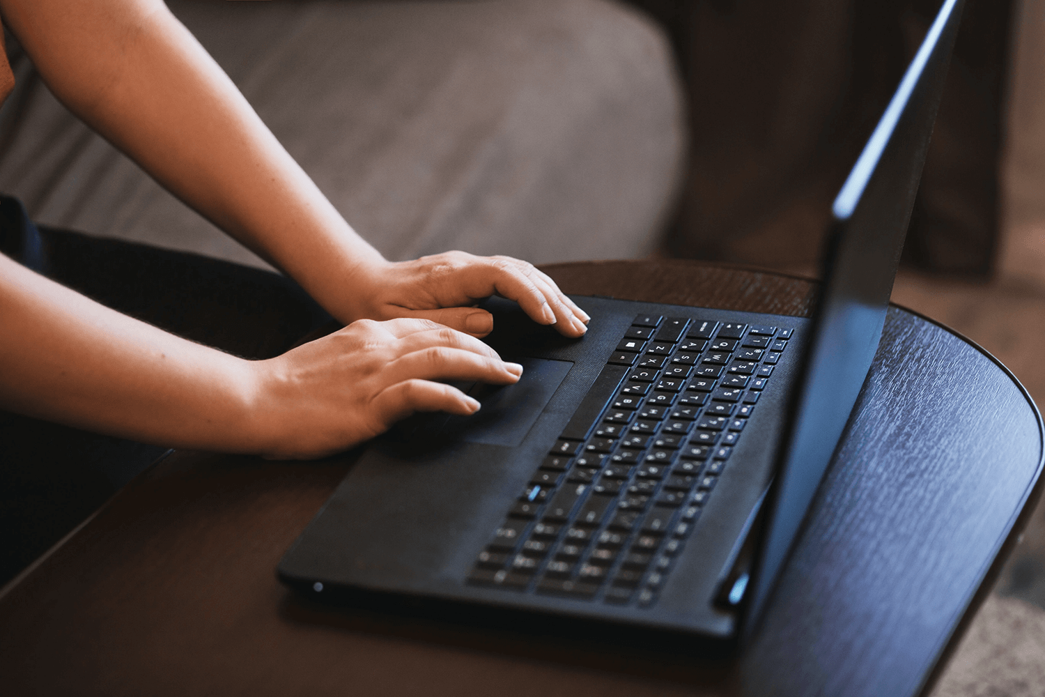 A person typing on a laptop 