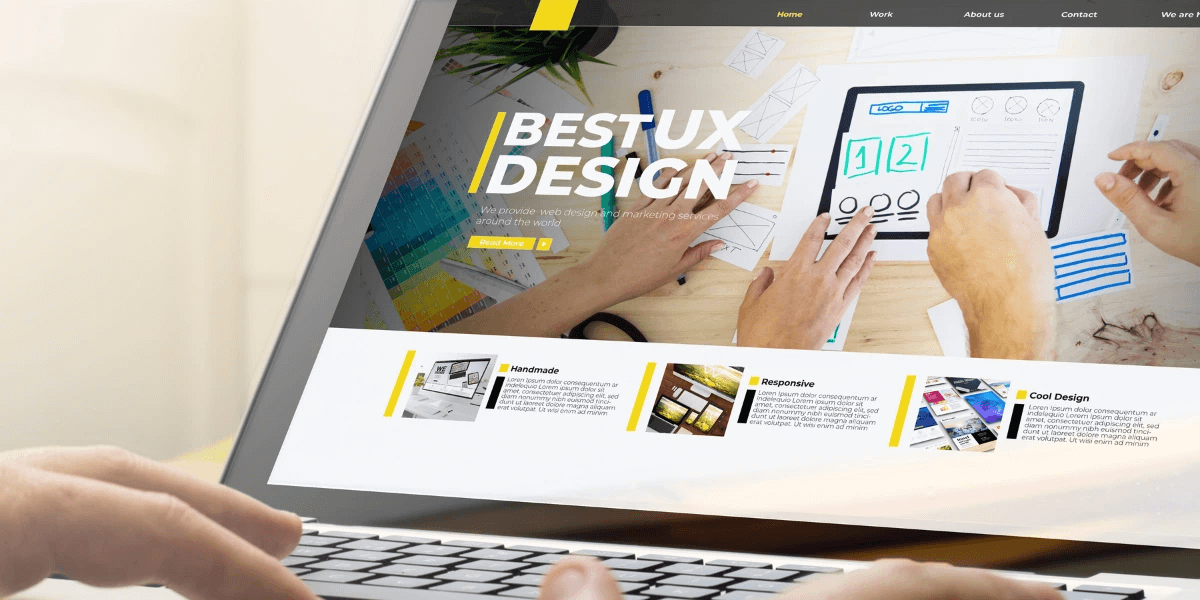 A person using a laptop that shows a webpage with the words Best UX Design