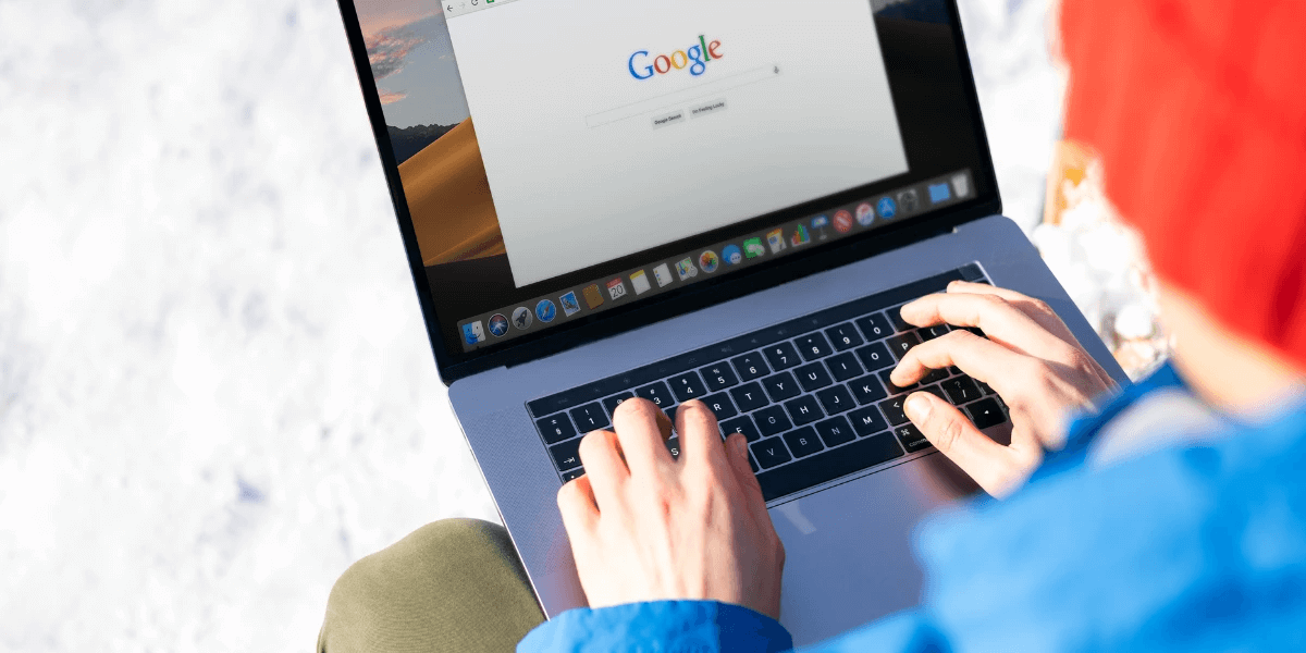 A person using a laptop to search for something on a search engine