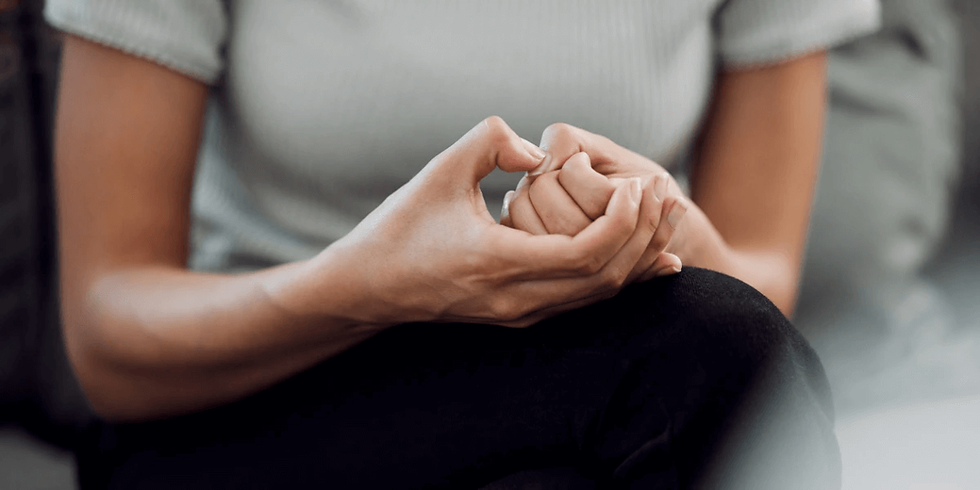 Closeup of a young woman's hands while she picks on the skin of her nails - a sign of anxiety