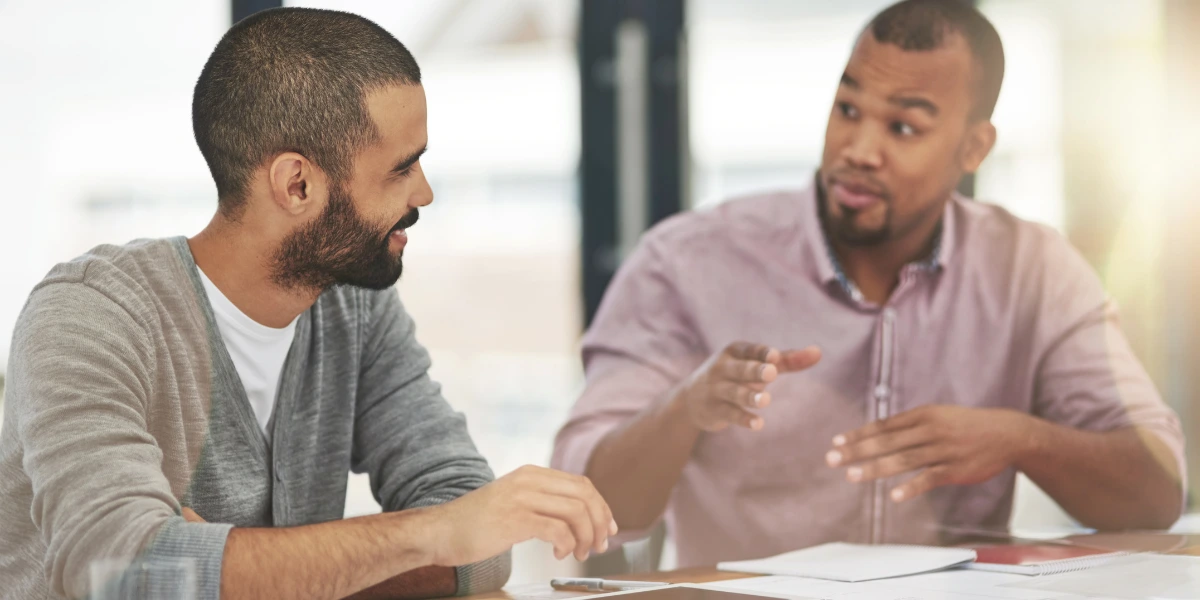 Two people discussing local and national SEO strategies