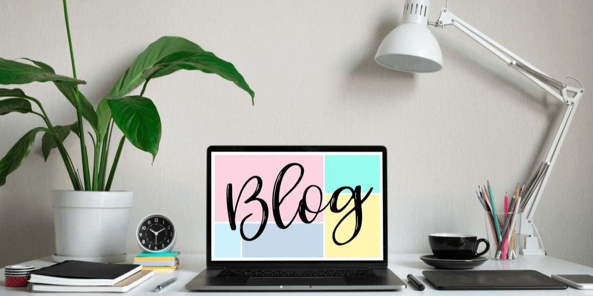 A laptop with the words Blog written in cursive on the screen