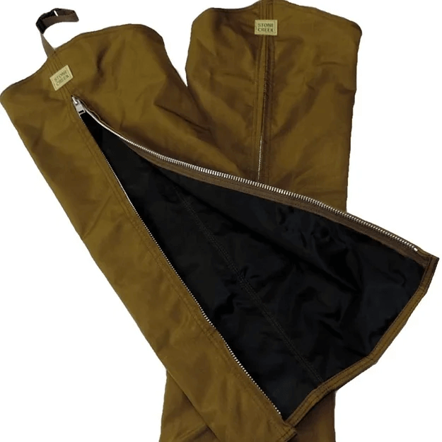 Stone Creek Hunters Choice Chaps. Image shows one chap leg with open zipper while the other behind it has a closed one