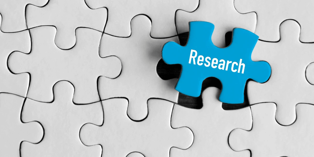 Blue puzzle piece with the word 'Research' on it to portray the importance of research in a geo-targeting strategy