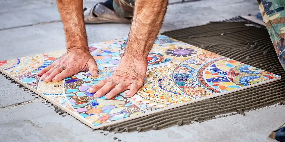 Man laying down a colorful ceramic tile