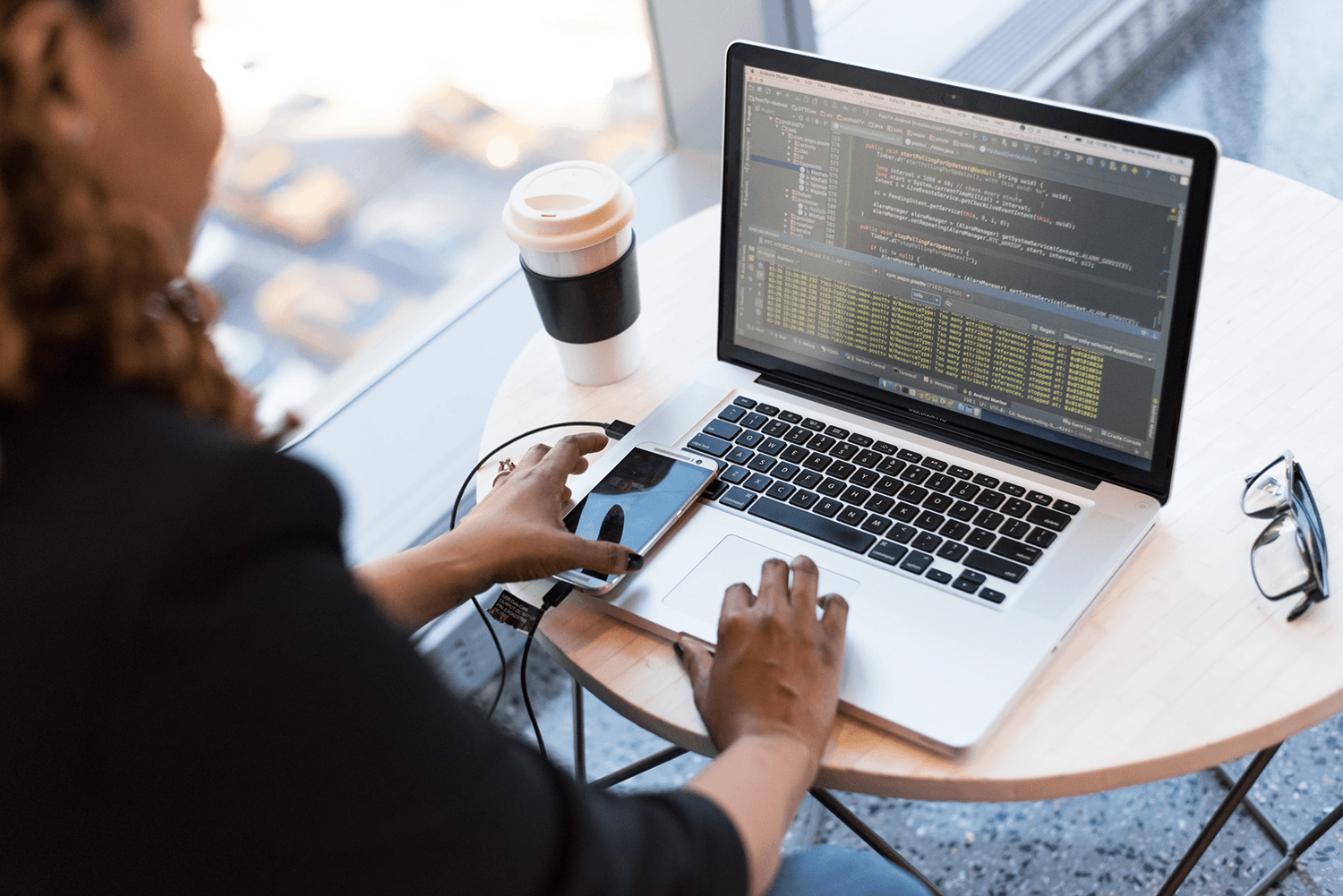 An image illustrating the process of custom development with a programmer working on a project