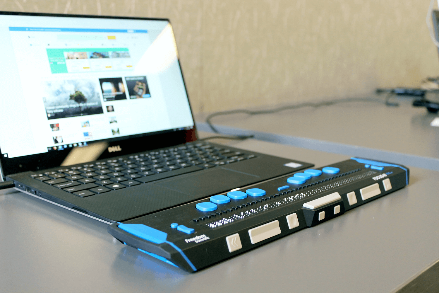 A laptop showing a website that has integrations for blind users