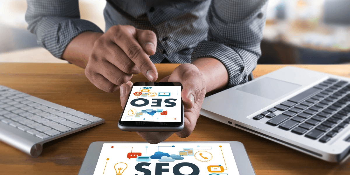 A person using a laptop, phone, and tablet to research local SEO citation services; local seo concept