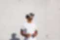 Stylish man in a white t-shirt wearing virtual reality goggles while standing outside