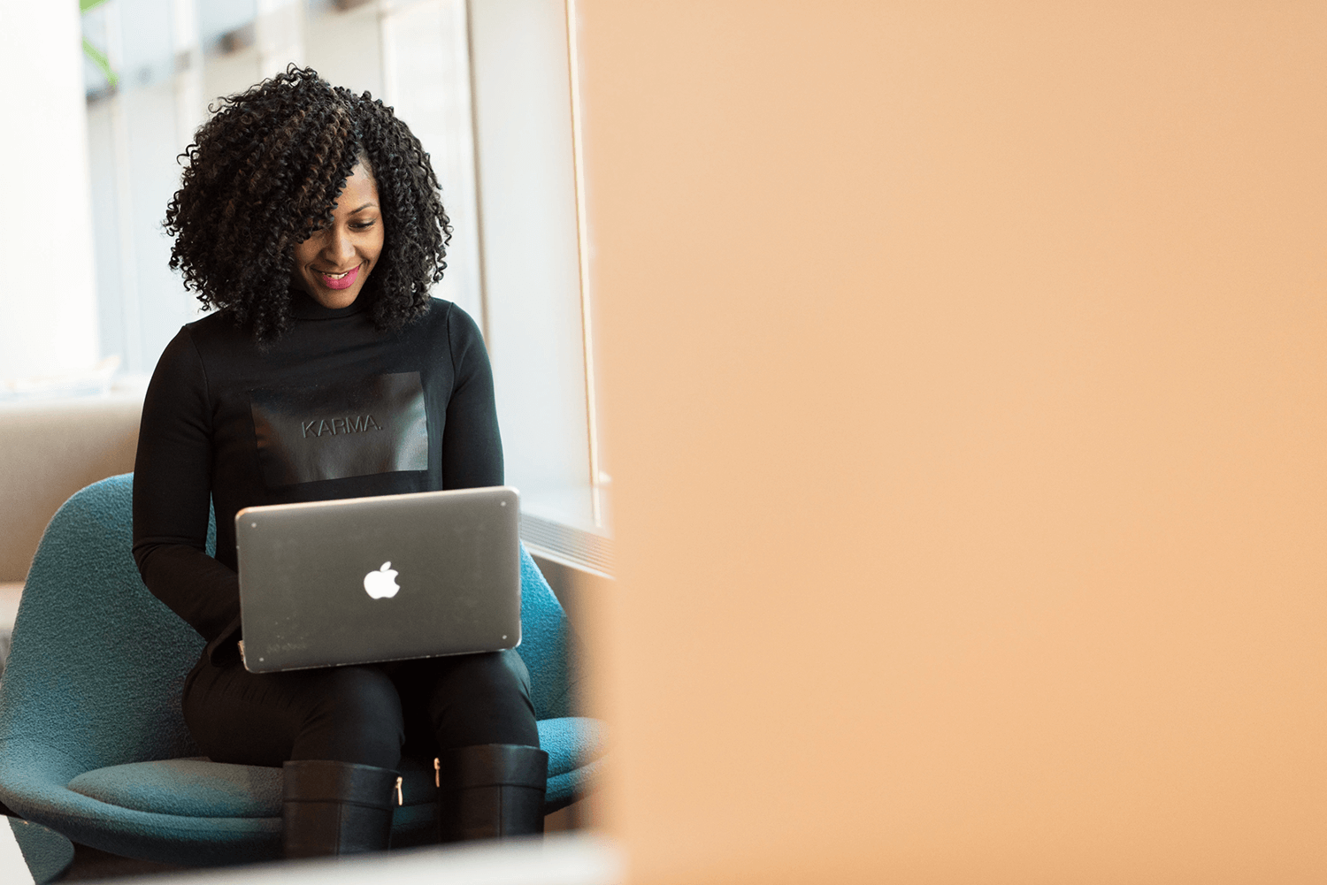 Designer in front of a laptop, optimizing a website