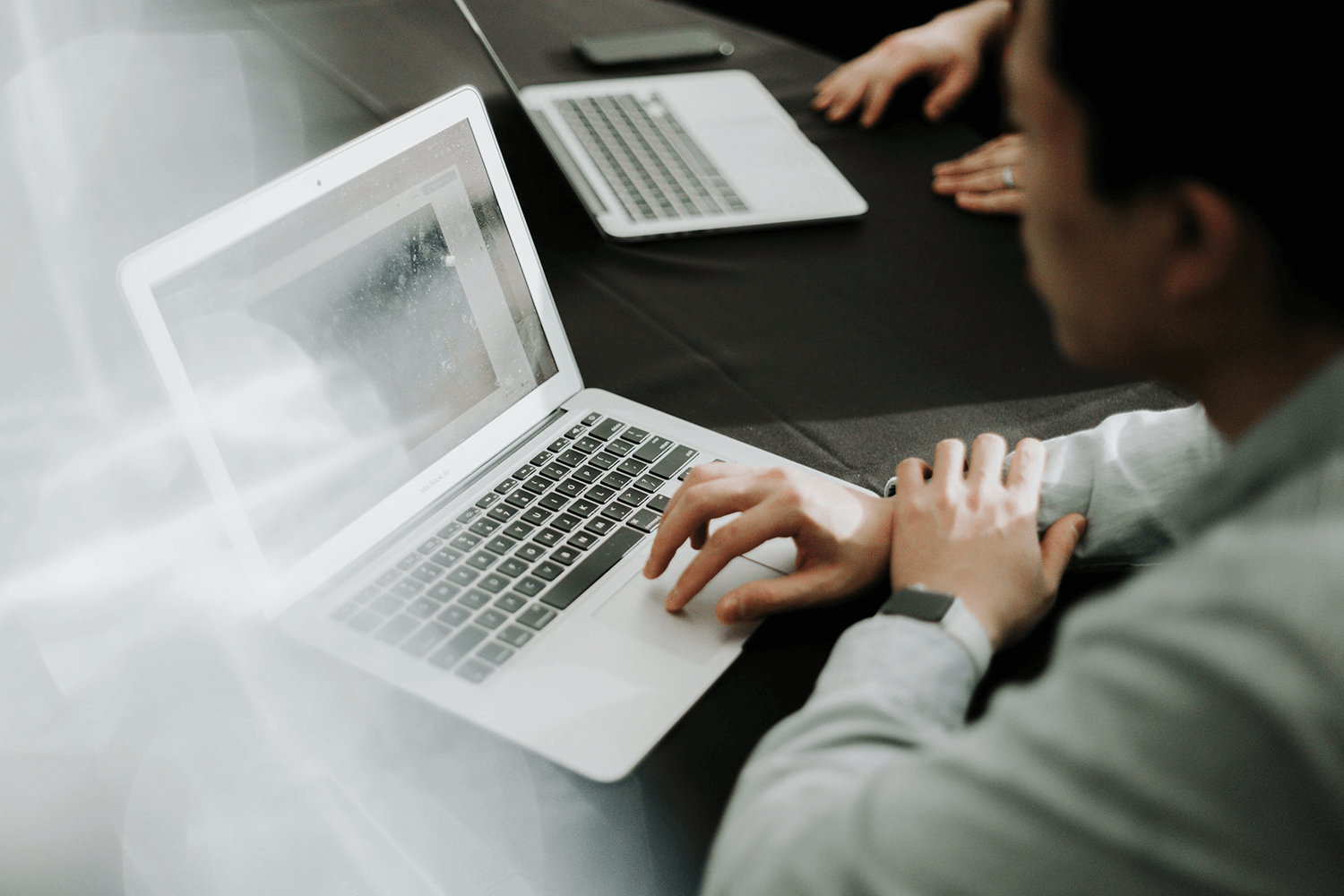 A laptop with a person looking at CMS trends