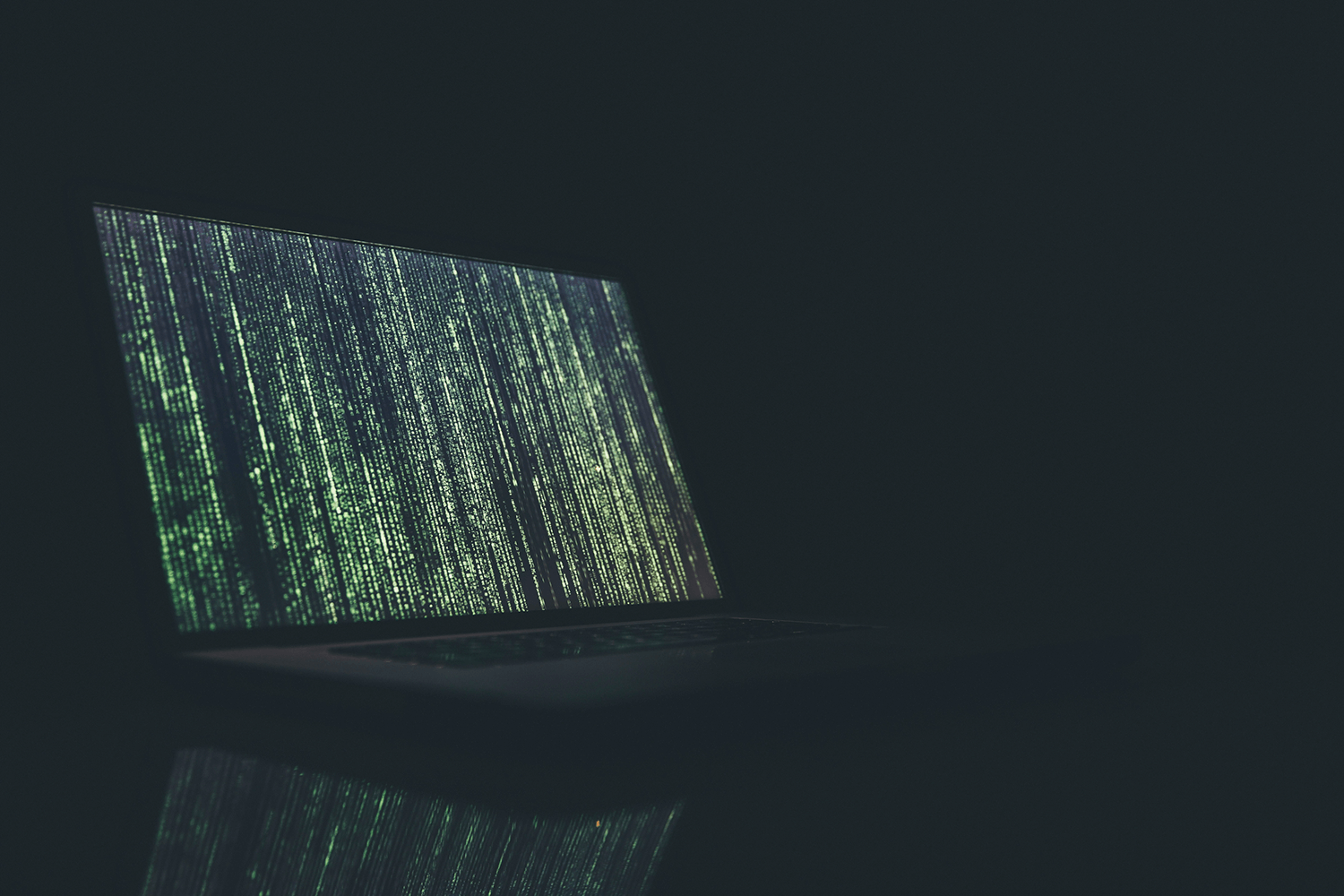 A laptop showing a screen of code
