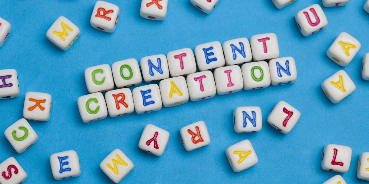 White blocks with different colored letters on all six of their sides. In the middle of the image are the words 'Content Creation' spelled out by some of the blocks