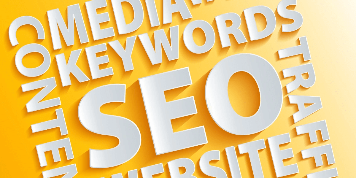 Words on yellow paper that include SEO, keywords, and content