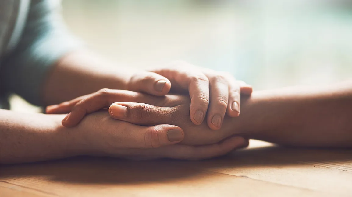 two hands holding each other
