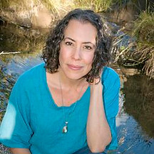 Headshot of Darci Meyers in front of a river.