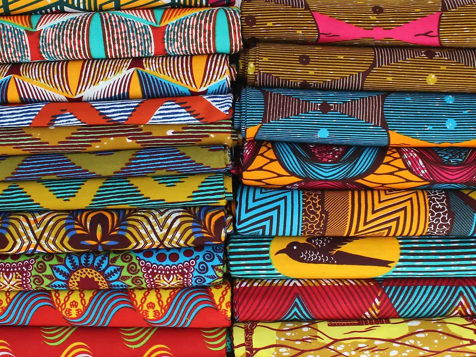 Eye-level view of colorful African fabric rolls displayed in a boutique