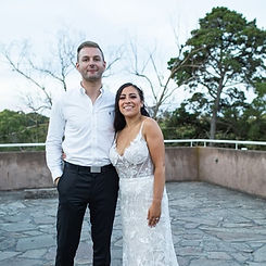 Cass and Albert with Benn Stone, their Melbourne cityside celebrant, celebrating their unforgettable wedding day. The couple thanks Benn for his incredible work as their celebrant, MC, and DJ, praising his fun, charming, and caring personality. They highlight his thoughtful gestures, like bringing food and drinks, helping with the dress, and spending time with them before the reception. They call him a true professional who makes the day feel personal and special, and highly recommend Benn as a top wedding celebrant in Melbourne.