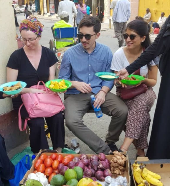 The African Foodtrail team leadiing tourists in enjoying street delicacies along mombasa streets