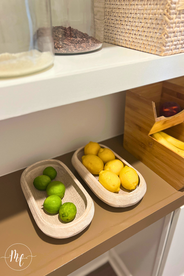 Whitewashed wooden bowls to organize citrus in the pantry. 
